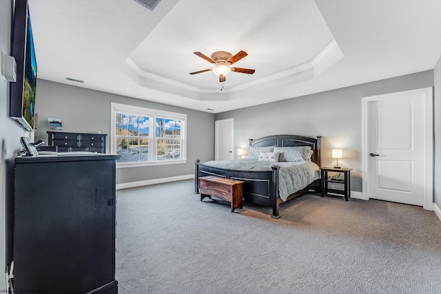 bedroom with crown molding, baseboards, a raised ceiling, and carpet flooring