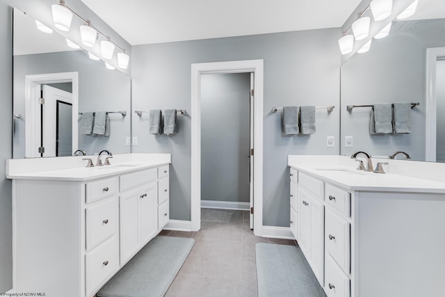 full bathroom featuring two vanities, a sink, and tile patterned floors