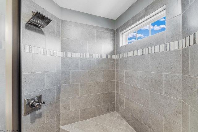 bathroom with tiled shower