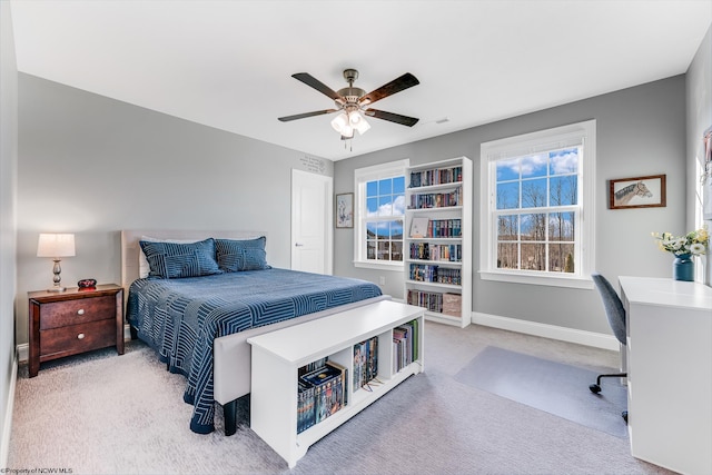 carpeted bedroom with visible vents, ceiling fan, and baseboards