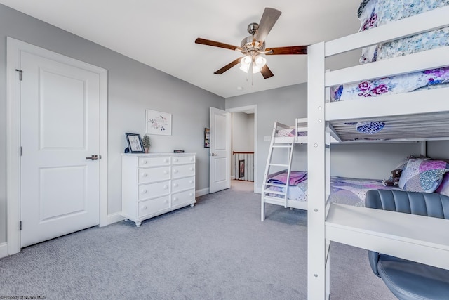 bedroom featuring baseboards, a ceiling fan, and light colored carpet