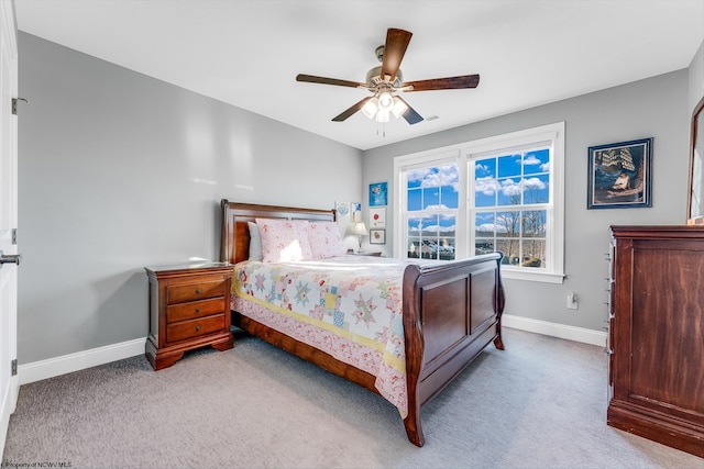 carpeted bedroom featuring ceiling fan and baseboards