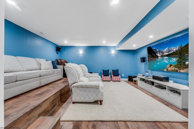 living area with recessed lighting, visible vents, baseboards, and wood finished floors