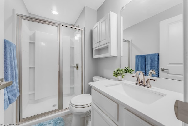 full bathroom with a stall shower, vanity, and toilet