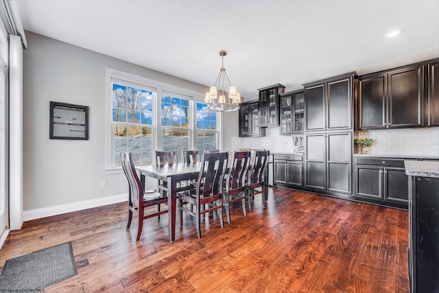 dining area with a notable chandelier, baseboards, dark wood-style flooring, and recessed lighting