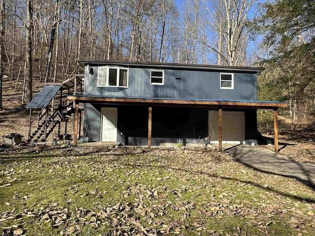 exterior space featuring a garage and stairs