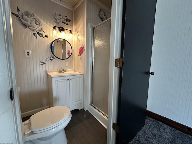 bathroom featuring toilet, wood finished floors, a shower stall, and vanity