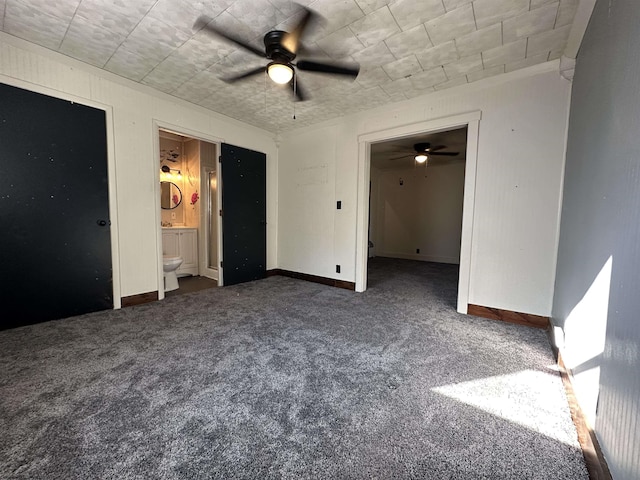 unfurnished bedroom featuring ensuite bathroom, carpet, a ceiling fan, and baseboards