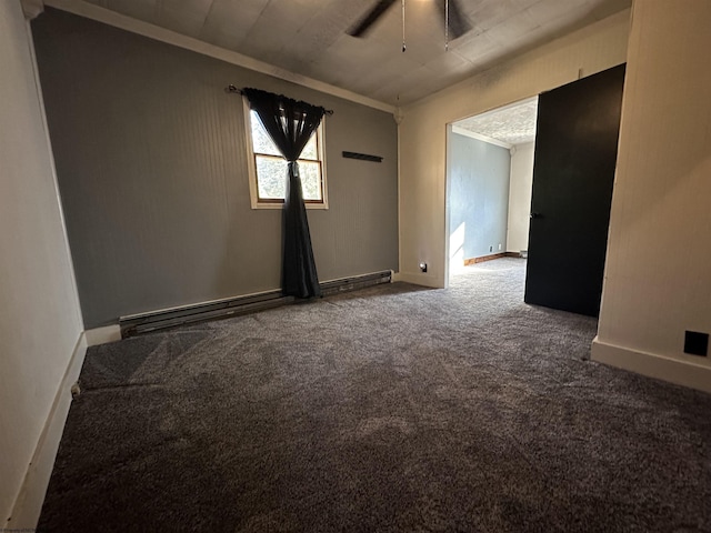 carpeted spare room featuring ceiling fan and baseboards