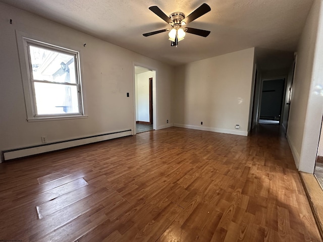 unfurnished room featuring baseboards, a ceiling fan, a baseboard radiator, wood finished floors, and a textured ceiling