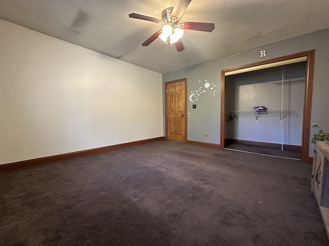 unfurnished bedroom featuring ceiling fan, dark colored carpet, a closet, and baseboards