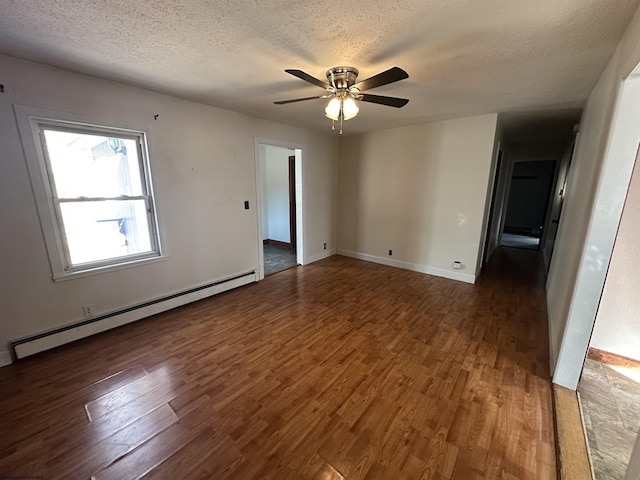 unfurnished room with a baseboard radiator, a textured ceiling, and wood finished floors