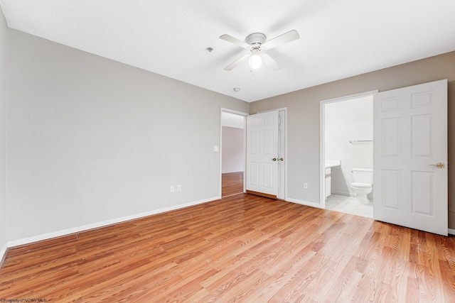 unfurnished bedroom with ceiling fan, light wood finished floors, ensuite bath, and baseboards