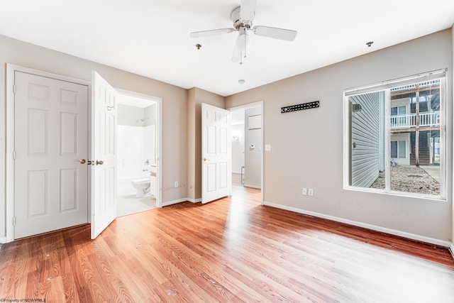 empty room with light wood-type flooring, baseboards, and a ceiling fan