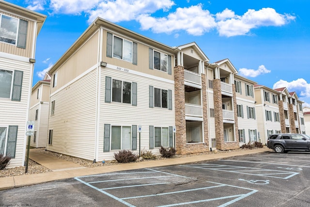 view of property with uncovered parking