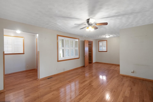 3508 Old Mill Rd, Weston, WV 26452 - spare room featuring a textured ceiling, ceiling fan, visible vents, and light wood-style flooring