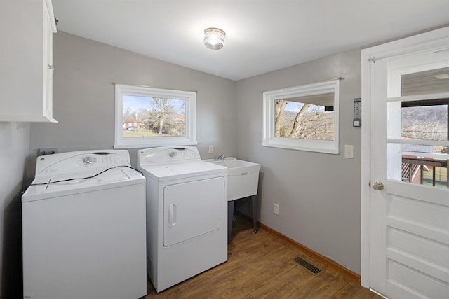 3508 Old Mill Rd, Weston, WV 26452 - clothes washing area with wood finished floors, washing machine and clothes dryer, visible vents, and baseboards