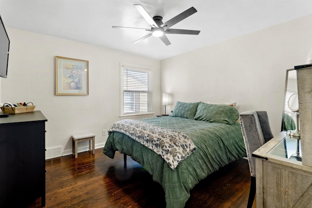 bedroom featuring ceiling fan, wood finished floors, visible vents, and baseboards