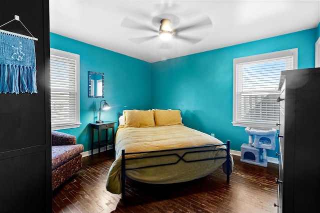 bedroom featuring wood finished floors, a ceiling fan, and baseboards