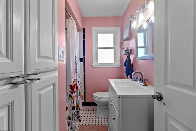 bathroom with toilet, curtained shower, and vanity