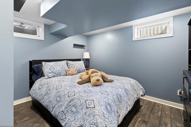 bedroom featuring baseboards and wood finished floors