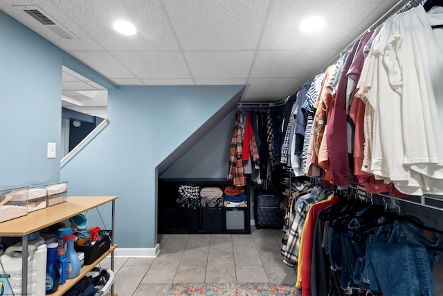 spacious closet featuring a drop ceiling, tile patterned flooring, and visible vents