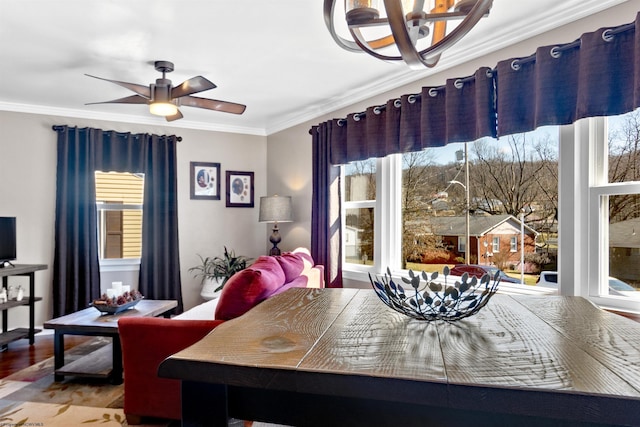 dining room featuring ceiling fan, wood finished floors, and crown molding