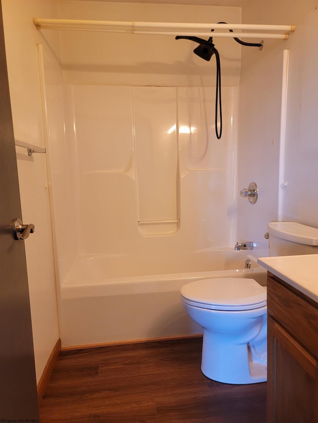 bathroom with vanity, shower / tub combination, wood finished floors, and toilet