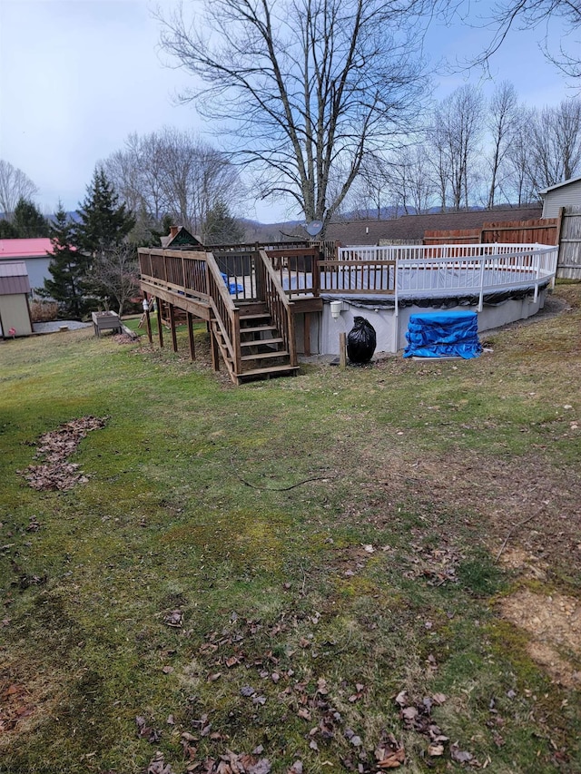 view of yard with a covered pool, stairway, and a deck