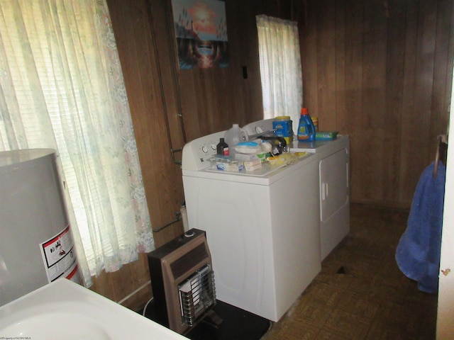 laundry area with laundry area, wood walls, and separate washer and dryer