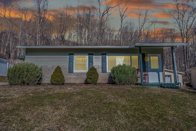 view of front of property with a front lawn and brick siding