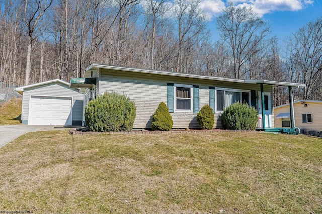 view of front of property featuring a front lawn, concrete driveway, and an outdoor structure