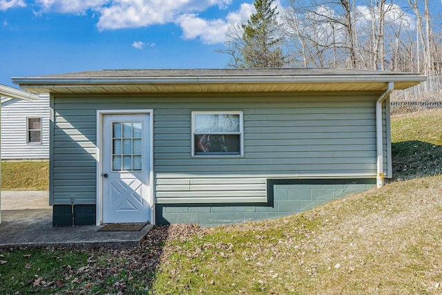 rear view of property featuring an outbuilding