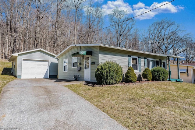 view of front of home with driveway, a garage, an outbuilding, and a front yard