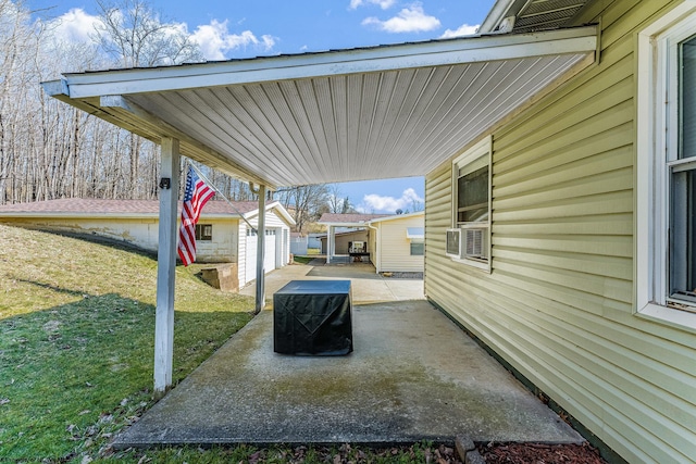 view of patio / terrace with an attached carport and an outdoor structure