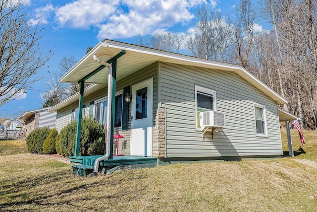 view of home's exterior featuring a yard and cooling unit