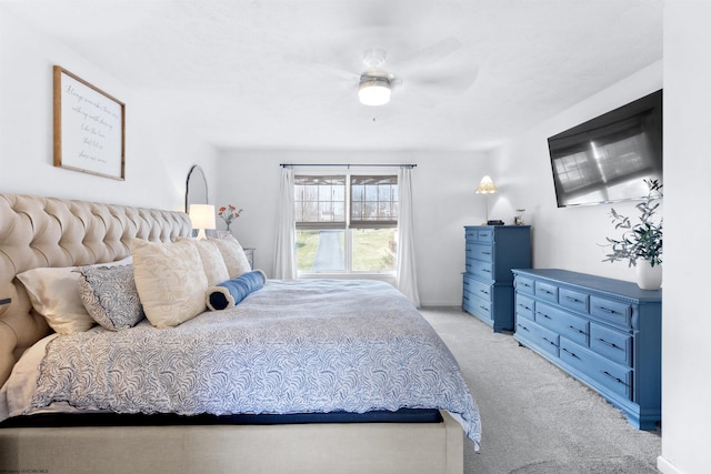 bedroom with light colored carpet, ceiling fan, and baseboards