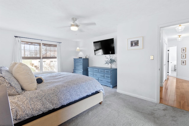 carpeted bedroom featuring ceiling fan and baseboards