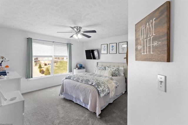 bedroom with carpet floors, a textured ceiling, baseboards, and a ceiling fan