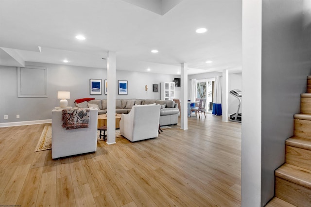 living area with light wood-style floors, recessed lighting, stairway, and baseboards