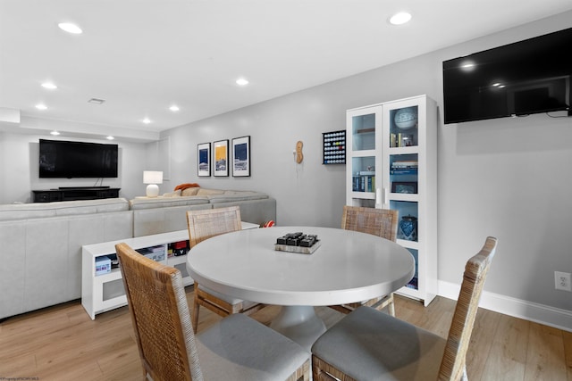 dining space with light wood-type flooring, baseboards, and recessed lighting