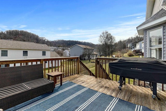 wooden deck featuring grilling area and a residential view