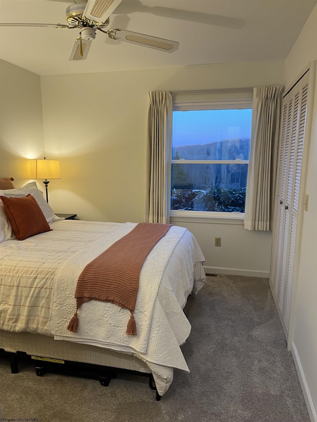 bedroom with ceiling fan, carpet floors, a closet, and baseboards