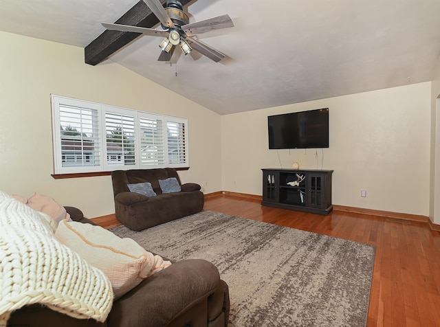 living room with lofted ceiling with beams, wood finished floors, a ceiling fan, and baseboards