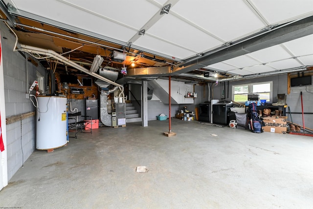 garage featuring heating unit, concrete block wall, water heater, and a garage door opener