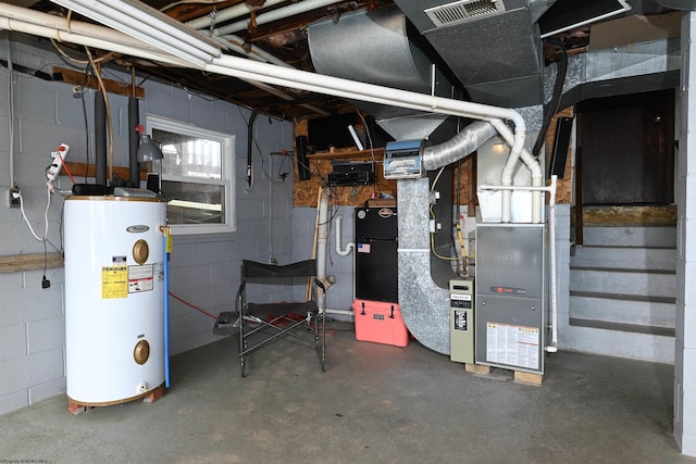 utilities featuring water heater, visible vents, and heating unit