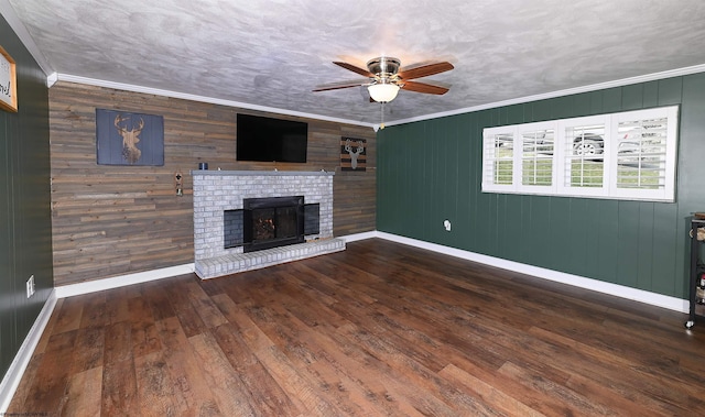 unfurnished living room featuring crown molding, wood-type flooring, a fireplace, and baseboards