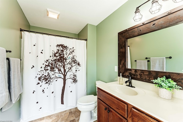 bathroom featuring toilet, curtained shower, and vanity