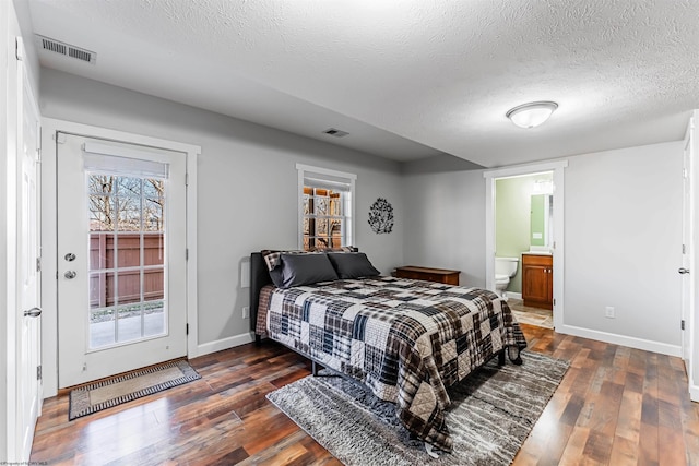 bedroom with dark wood-type flooring, visible vents, and baseboards