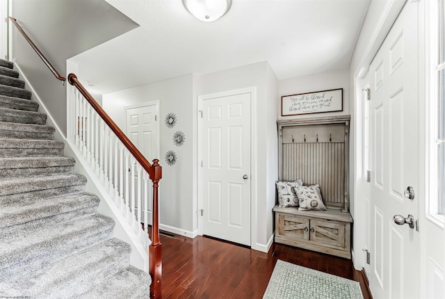 mudroom with dark wood-type flooring and baseboards